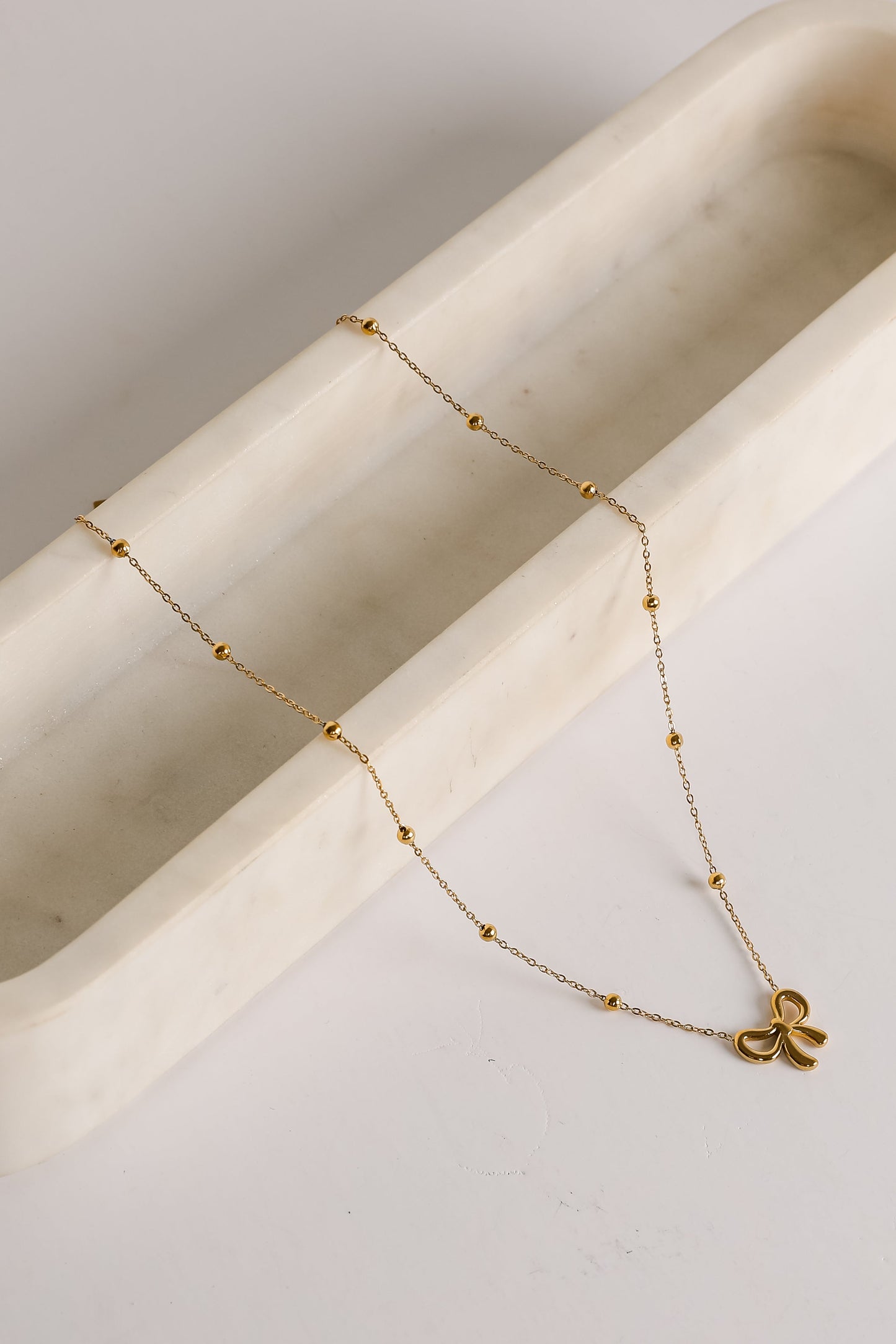 Elizabeth Gold Bow Charm Necklace